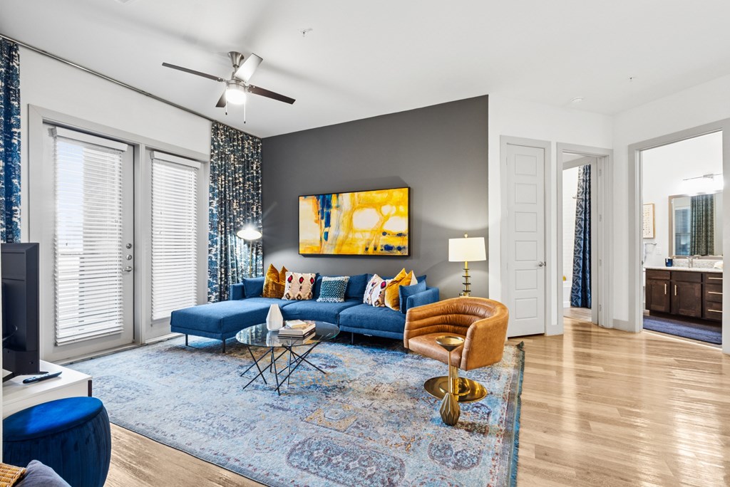 A living room with a blue couch and a yellow chair.