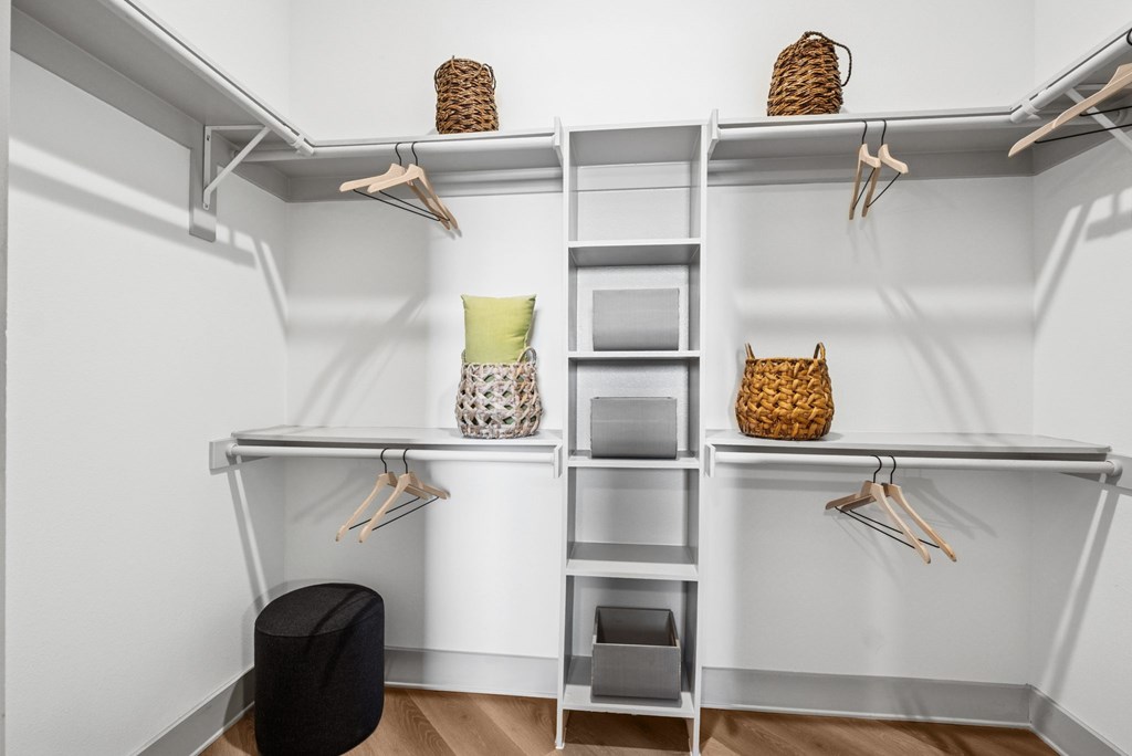A white closet with shelves and hangers.