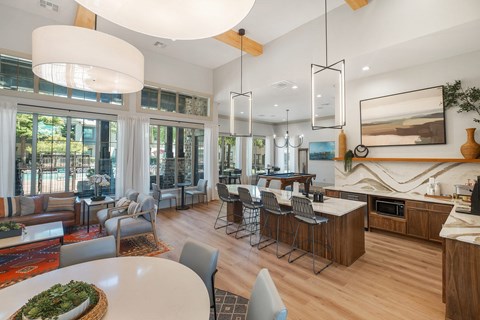 A modern kitchen and living room with a dining table and chairs.
