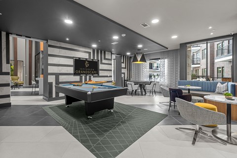 A billiard table is in the middle of a room with a pool table.