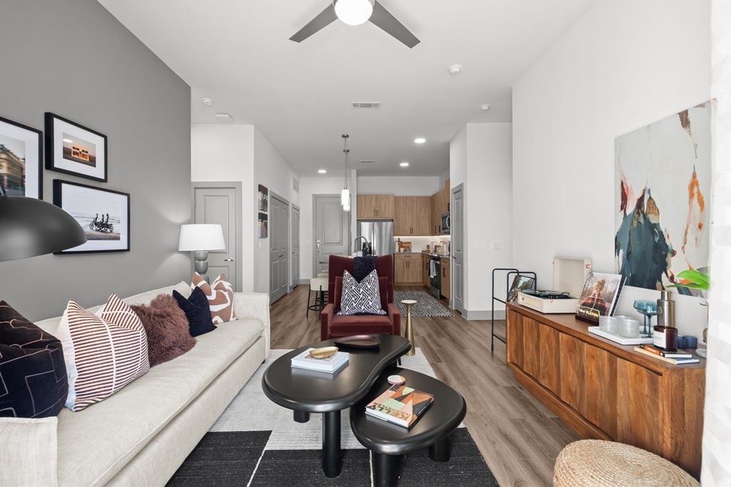A living room with a white couch and a black coffee table.