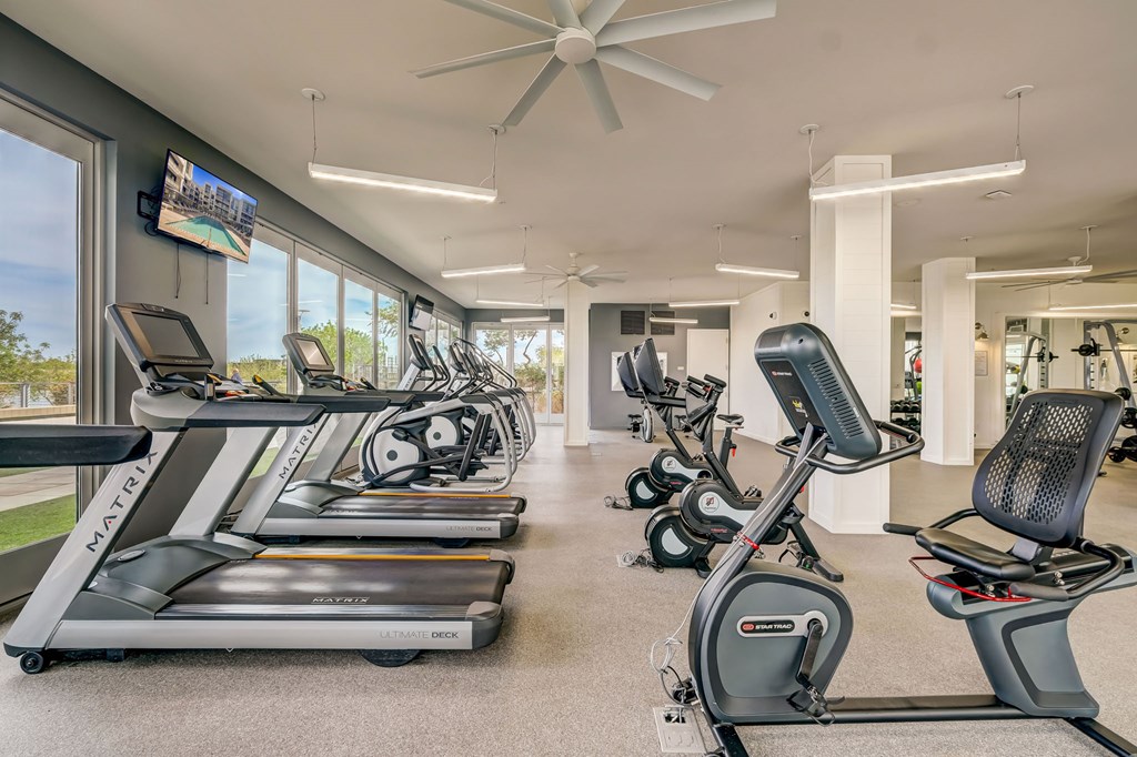 A gym with treadmills and exercise bikes.