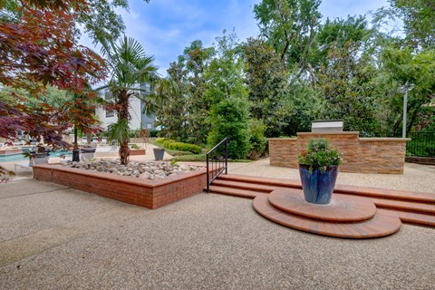 a fenced in area with stairs and a fountain