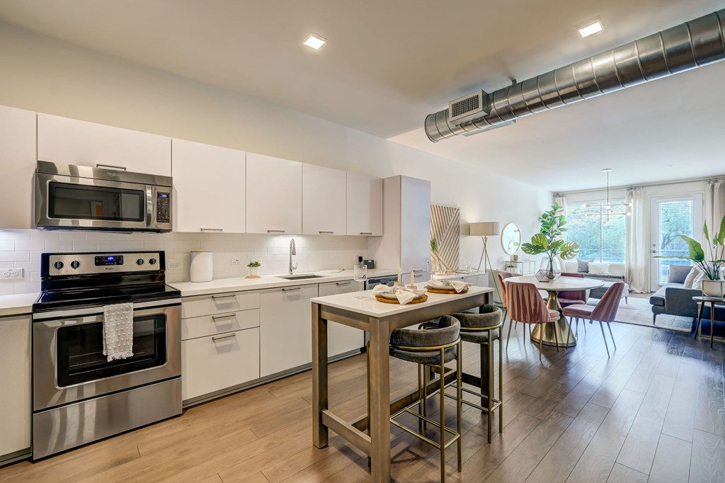 A modern kitchen with a dining table and chairs.