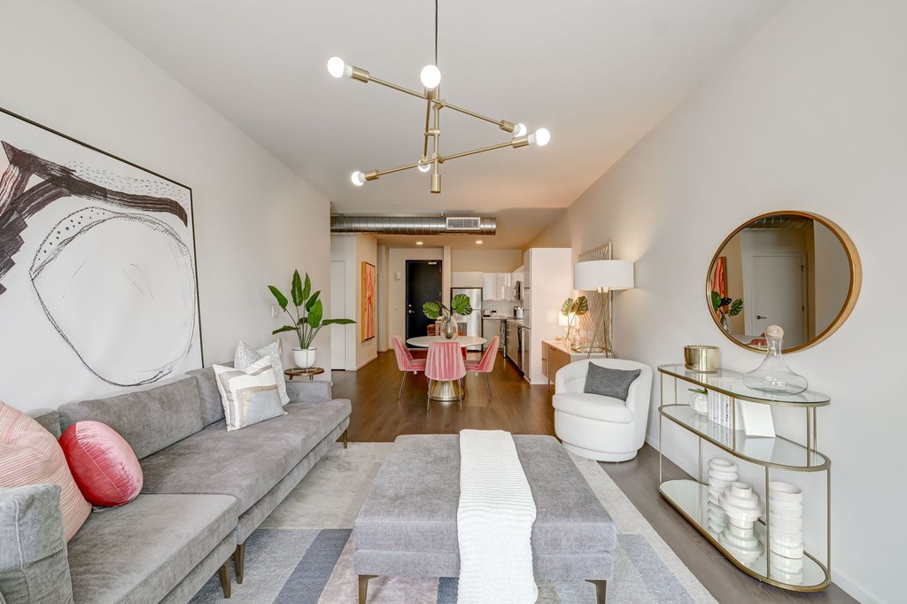A living room with a grey sofa and a grey coffee table.