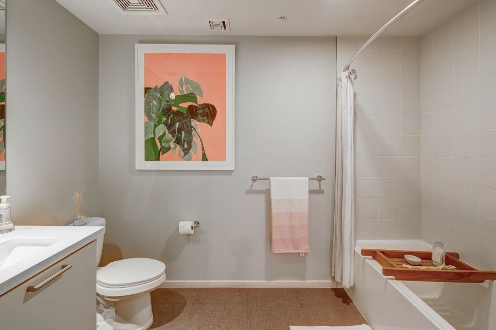 A bathroom with a toilet, sink, and bathtub.