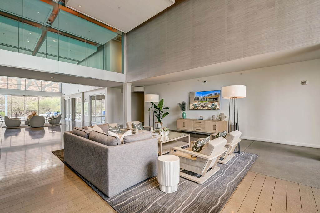 A modern living room with a grey sofa and a wooden coffee table.