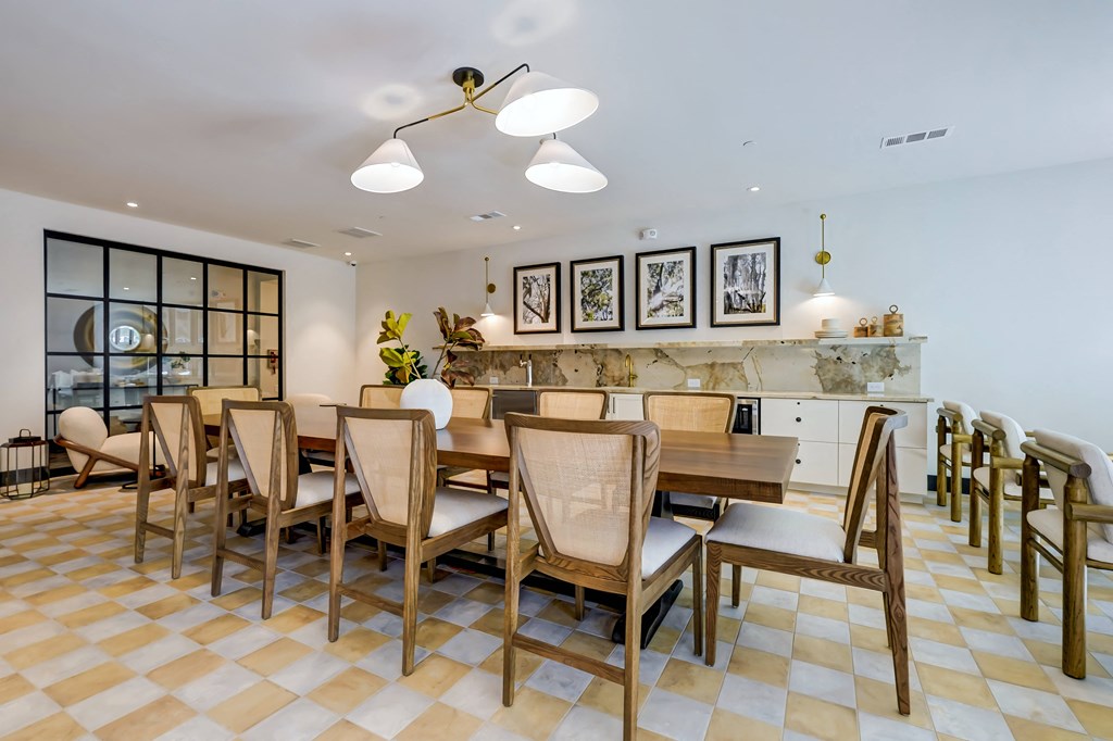 a dining room with a long wooden table and chairs