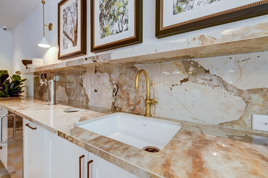 a kitchen with marble counter tops and a sink