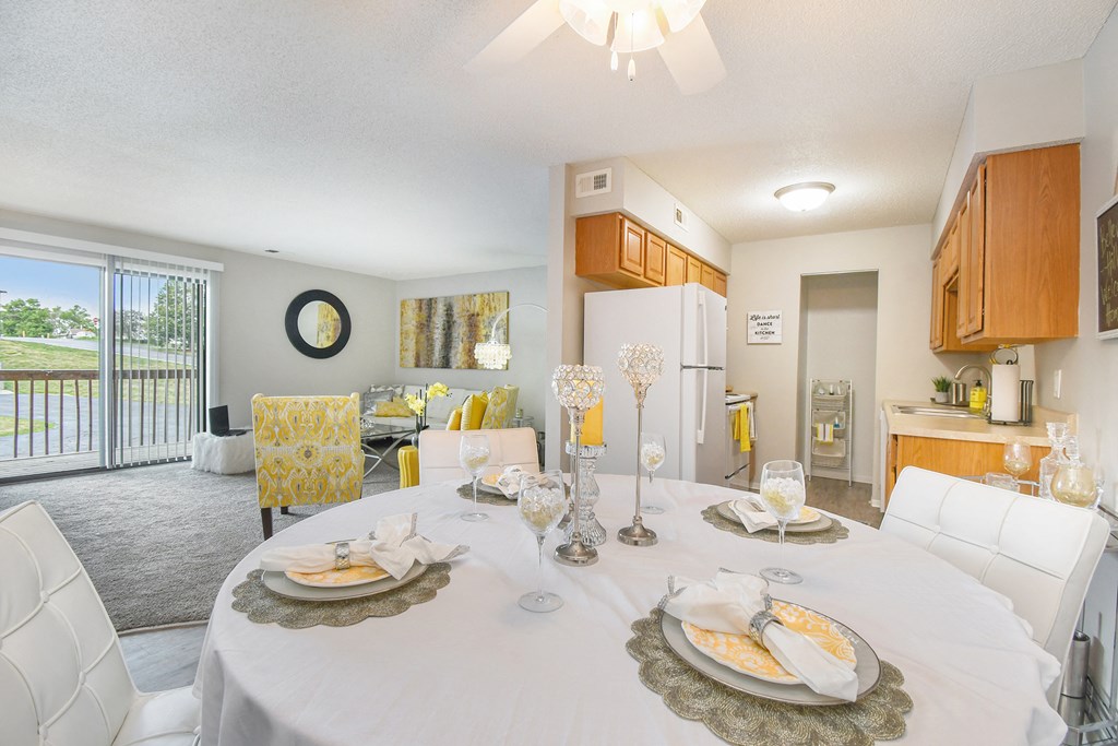 a dining room and living room with a table and chairs