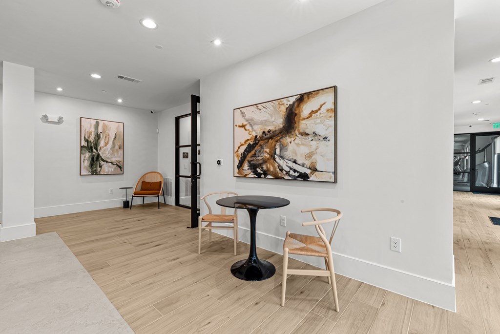 A room with a round table and chairs.