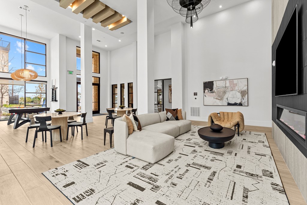 A modern living room with a large rug on the floor.
