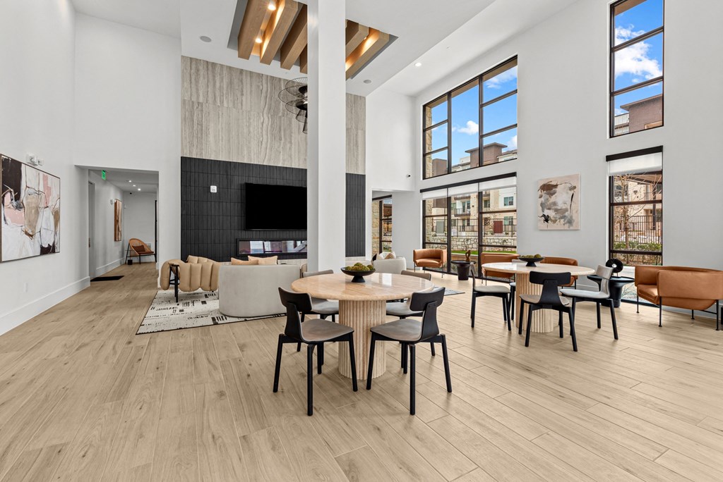 A spacious room with a long table surrounded by chairs.