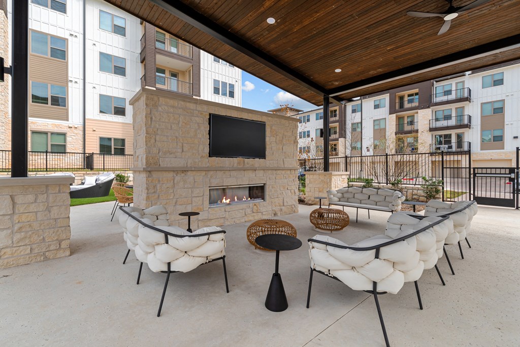 A patio with a fireplace and seating area.