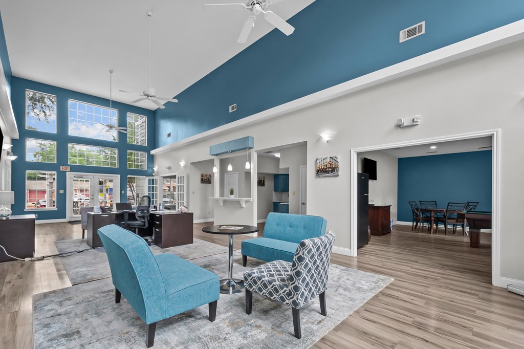 A living room with a blue chair and a patterned chair.