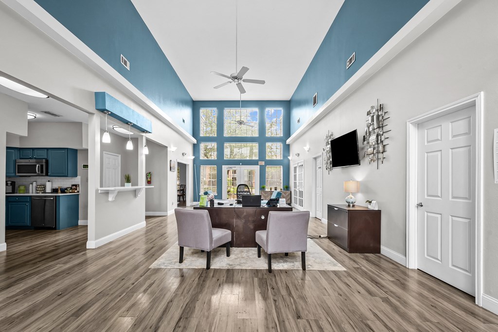 A modern kitchen with a dining area and a ceiling fan.