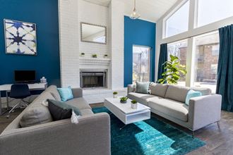 a living room with blue walls and a white fireplace