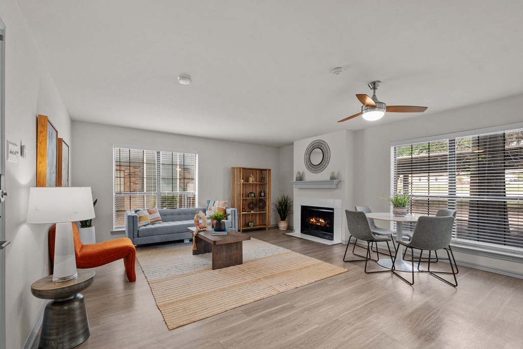 A modern living room with a fireplace and a dining area.