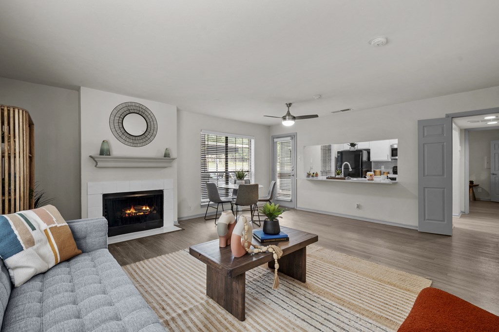 A modern living room with a fireplace and a grey sofa.