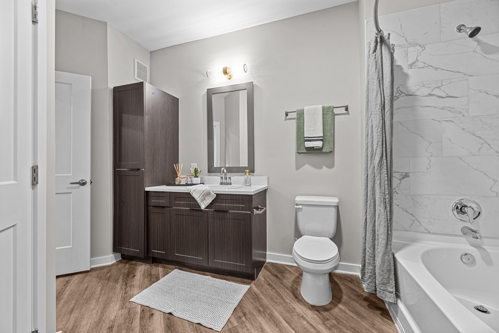 A bathroom with a toilet, sink, and bathtub.