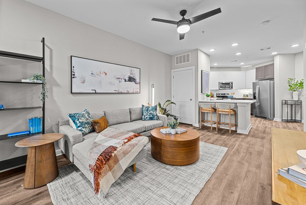 A living room with a grey couch and a coffee table.