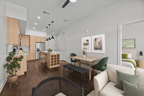 A modern living room with a dining table and chairs.