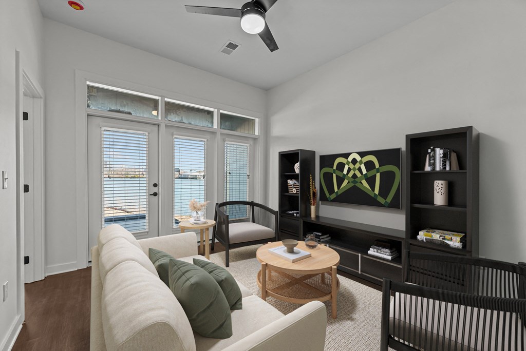 A living room with a white couch and a ceiling fan.