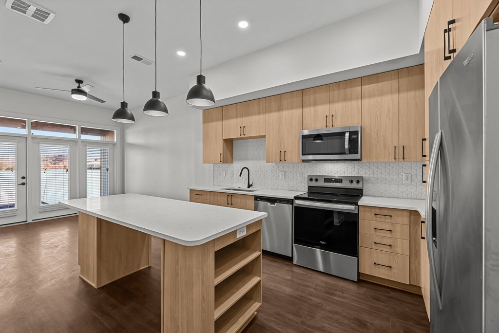 A modern kitchen with wooden cabinets and stainless steel appliances.