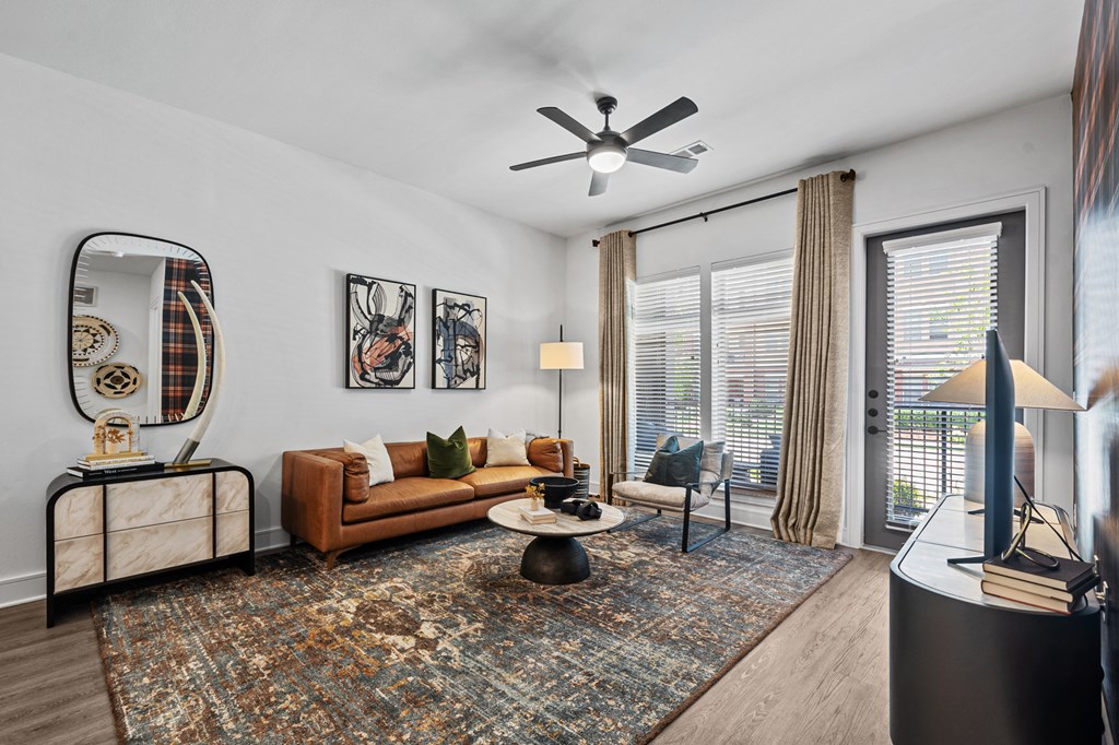 a living room with a couch and a ceiling fan