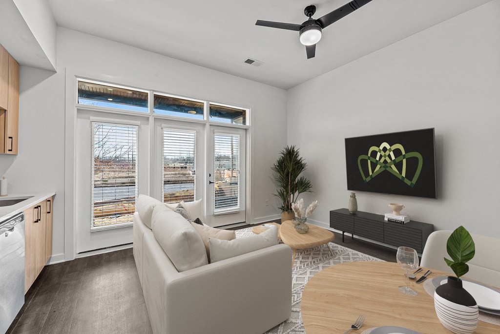 A modern living room with a large window overlooking a cityscape.