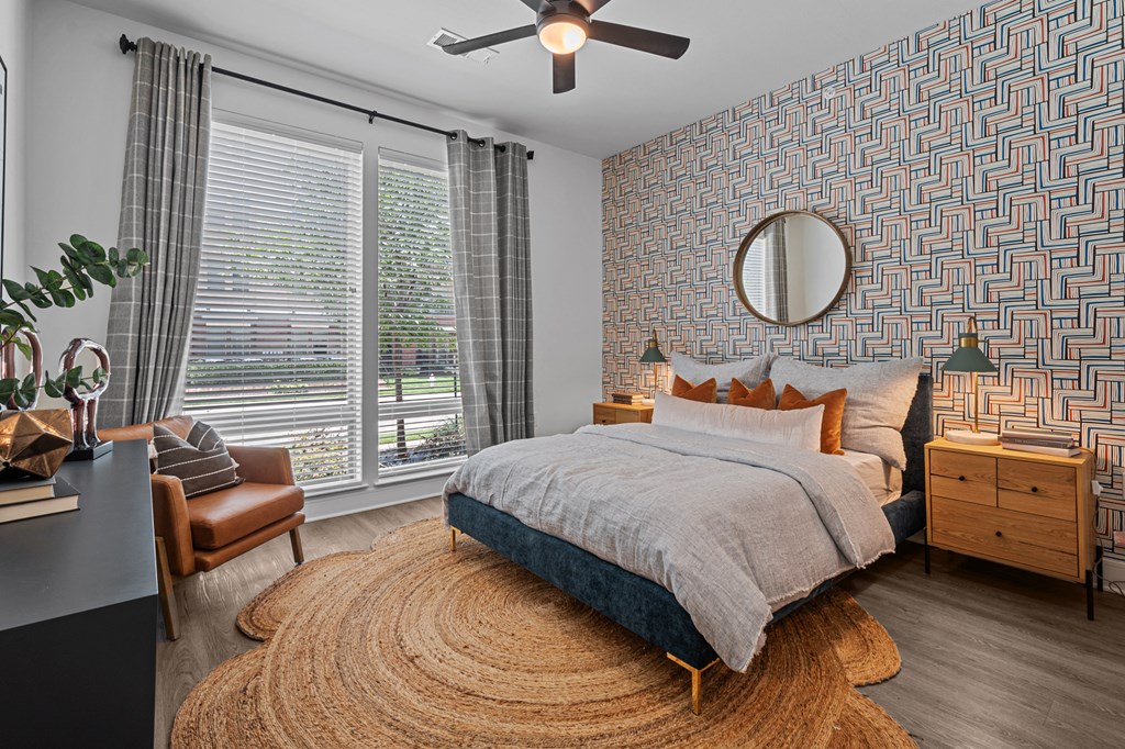 a bedroom with a bed and a ceiling fan