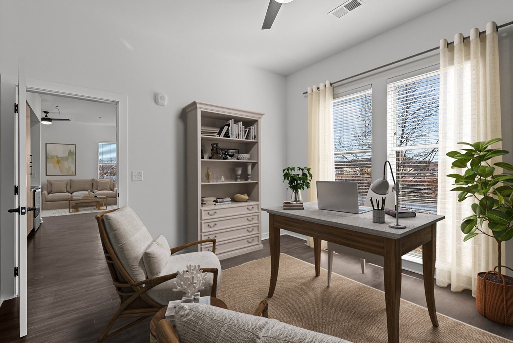 A room with a desk, chair, and bookshelf.