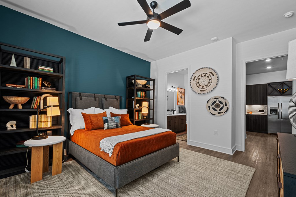 a bedroom with a bed and a ceiling fan