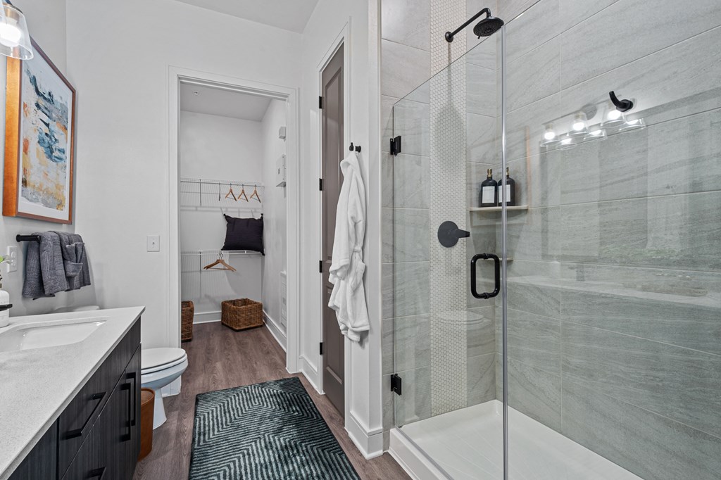 a bathroom with a shower and a sink and a toilet