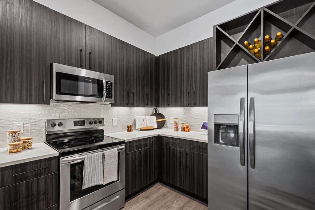 a kitchen with stainless steel appliances and brown cabinets
