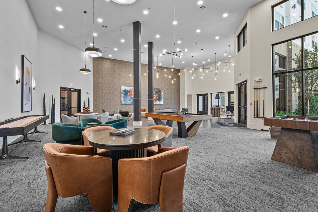 a clubhouse with tables and chairs and large windows