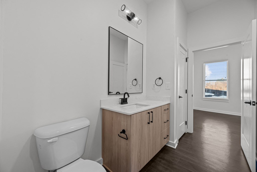 A white toilet sits next to a sink in a bathroom.
