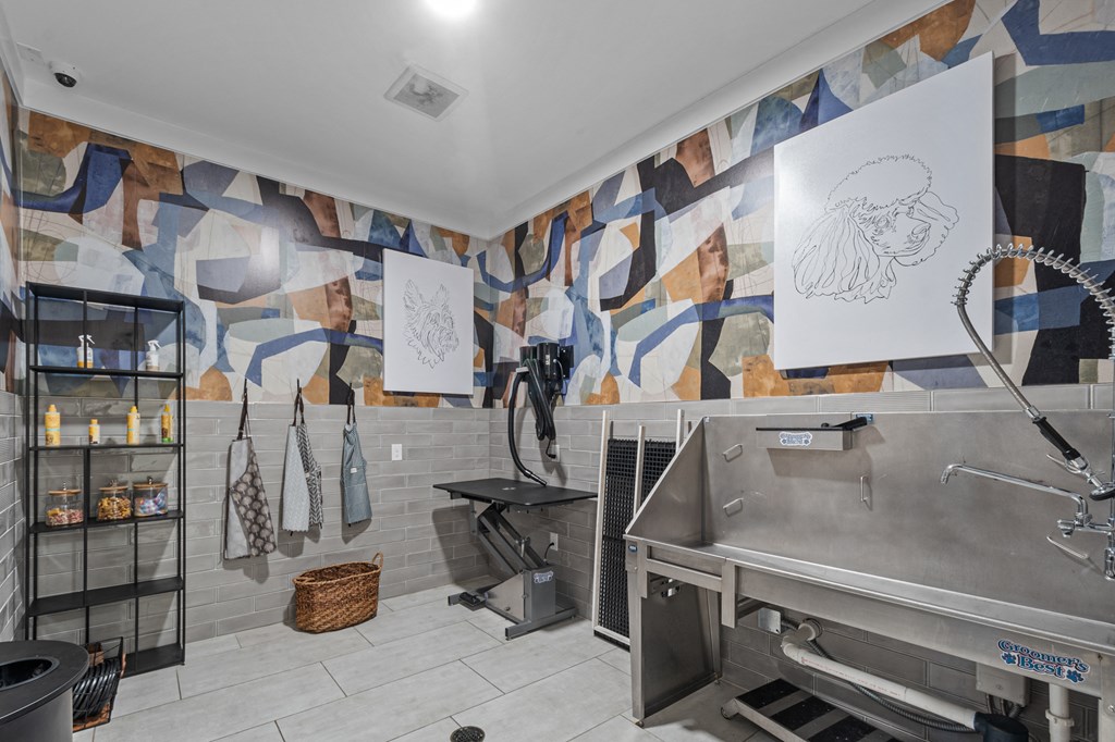 a kitchen with a large sink and a mural on the wall