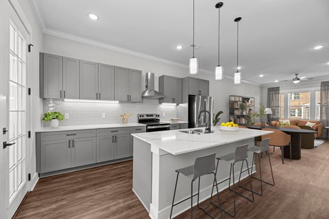 A modern kitchen with a large island and bar stools.