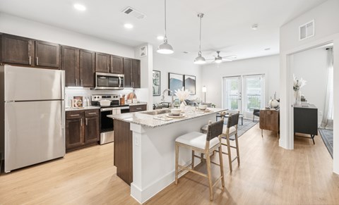 A kitchen with wooden cabinetry and granite countertops