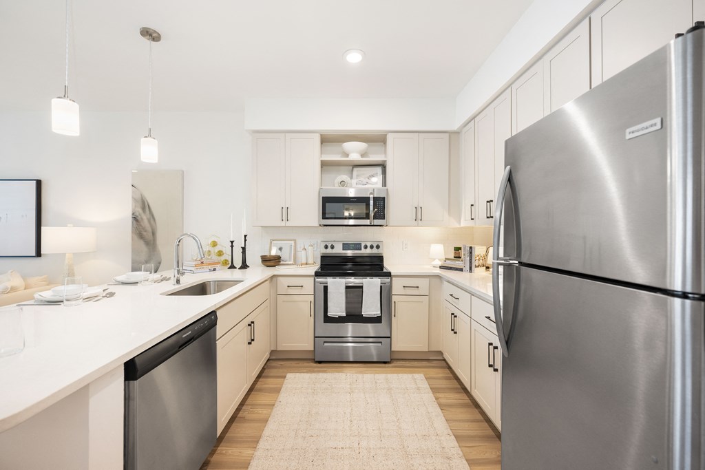 a kitchen with white cabinets and stainless steel appliances