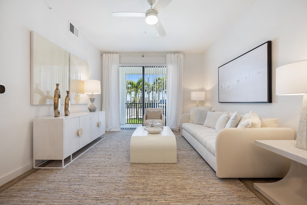 a living room with a white couch and a white coffee table
