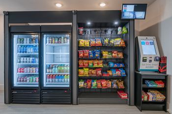 a refrigerator freezer sitting next to a vending machine