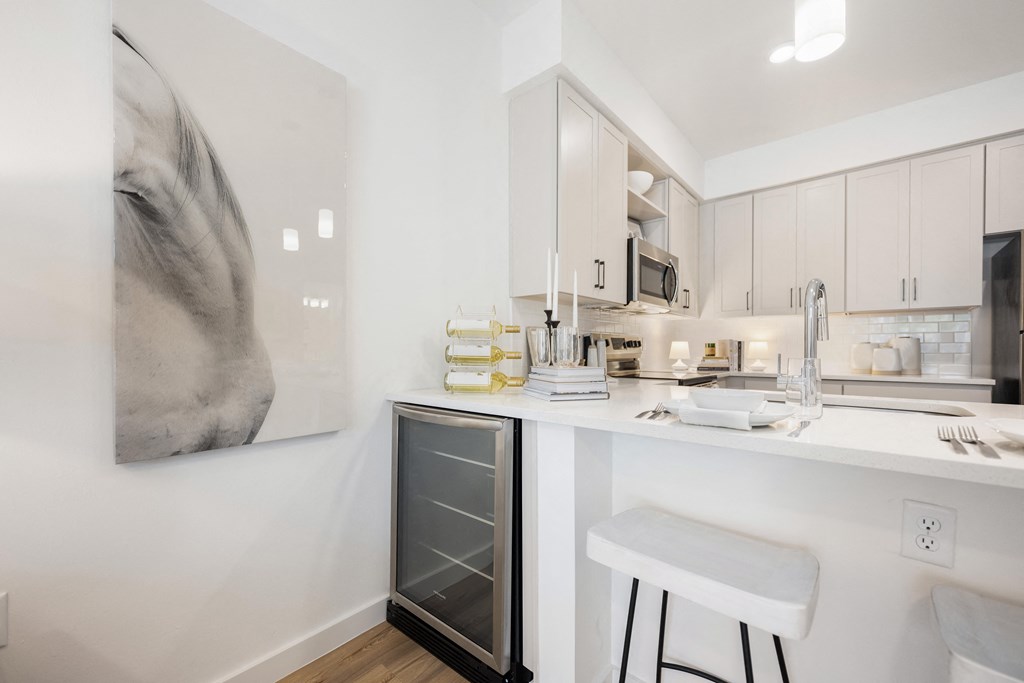 a kitchen with white cabinetry and a white counter top