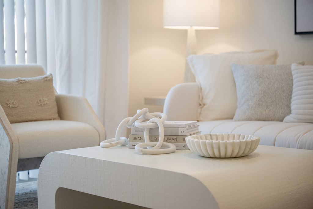 a living room with a white couch and a white coffee table