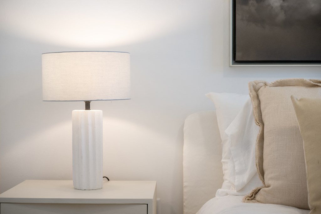 a lamp on a nightstand in a bedroom