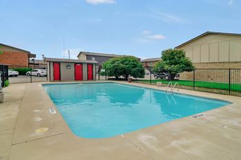 A small pool with a red door in the background.