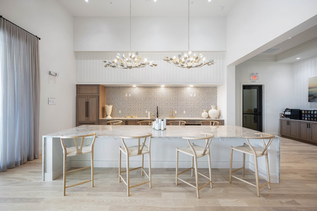 a kitchen with a large island with a marble countertop