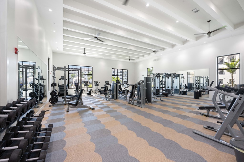 a spacious fitness center with treadmills and other exercise equipment