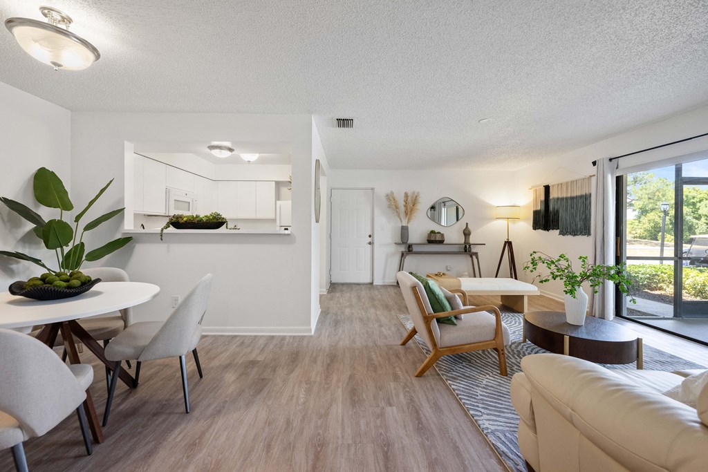 the living room and dining area of an apartment